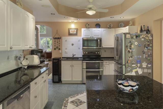 1729 Litchfield Rd, Watertown, CT 06795 - kitchen with stainless steel appliances, backsplash, recessed lighting, ceiling fan, and white cabinetry