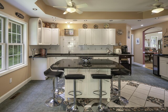 1729 Litchfield Rd, Watertown, CT 06795 - kitchen with a ceiling fan, baseboards, a sink, a breakfast bar, and recessed lighting