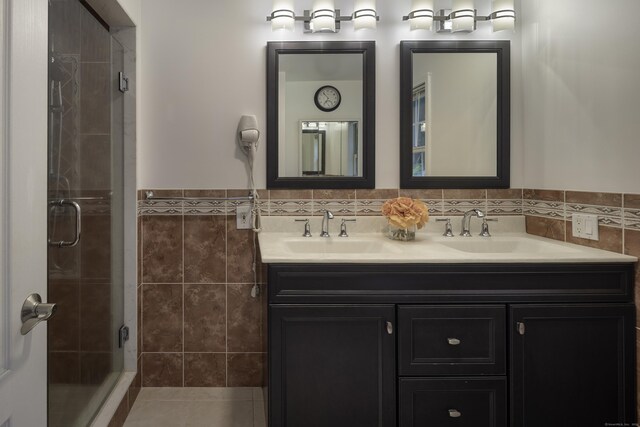 1729 Litchfield Rd, Watertown, CT 06795 - full bathroom featuring double vanity, a shower stall, tile walls, and wainscoting
