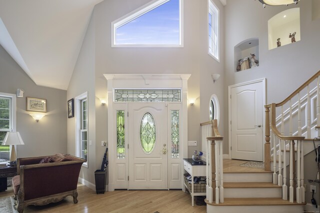 1729 Litchfield Rd, Watertown, CT 06795 - entrance foyer featuring plenty of natural light, wood finished floors, stairway, and high vaulted ceiling