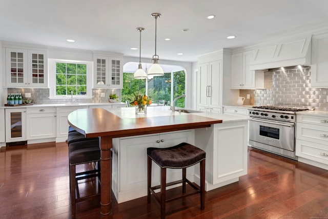 4 The Fenway, Westport, CT 06880 - kitchen with stainless steel range, beverage cooler, decorative backsplash, dark wood-style flooring, and recessed lighting