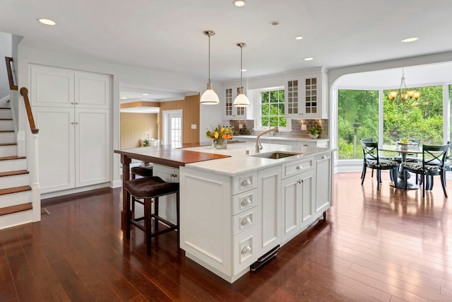 4 The Fenway, Westport, CT 06880 - kitchen with dark wood-style floors, a chandelier, a kitchen island with sink, white cabinets, and recessed lighting
