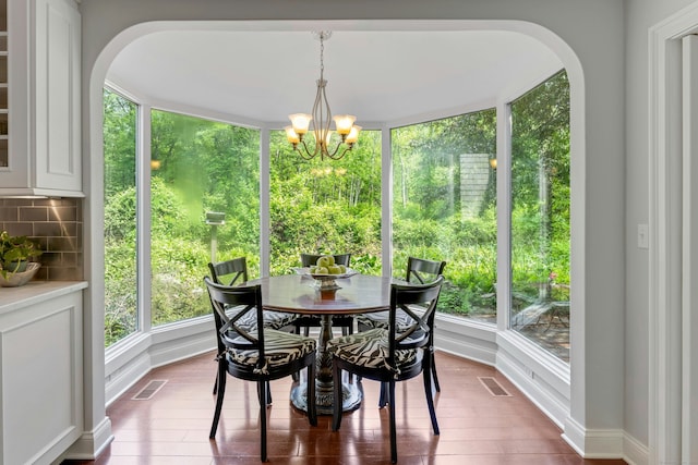 4 The Fenway, Westport, CT 06880 - dining room featuring arched walkways, a chandelier, and dark wood-style flooring