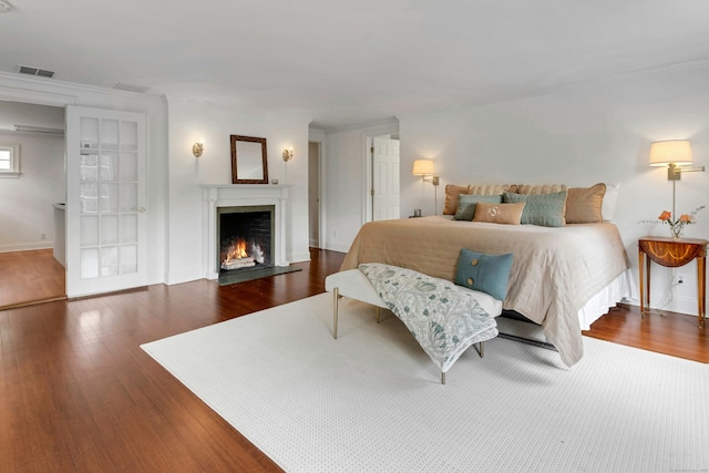 4 The Fenway, Westport, CT 06880 - bedroom with wood finished floors, a fireplace with flush hearth, and ornamental molding