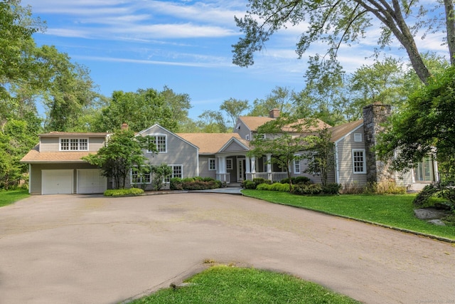 4 The Fenway, Westport, CT 06880 - shingle-style home featuring asphalt driveway, a garage, a porch, and a front lawn