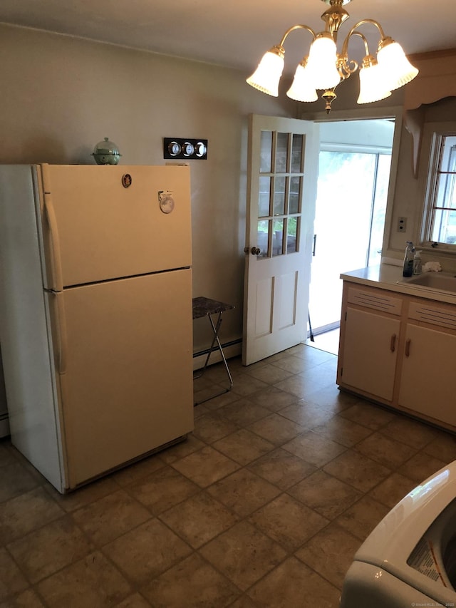 50 Richard Dr, Hamden, CT 06514 - kitchen with freestanding refrigerator, a baseboard heating unit, a chandelier, white cabinets, and light countertops