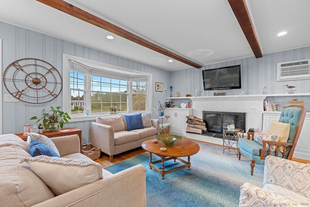 52 Seaside Ave, Guilford, CT 06437 - living room featuring beam ceiling, an AC wall unit, wood finished floors, a fireplace, and recessed lighting