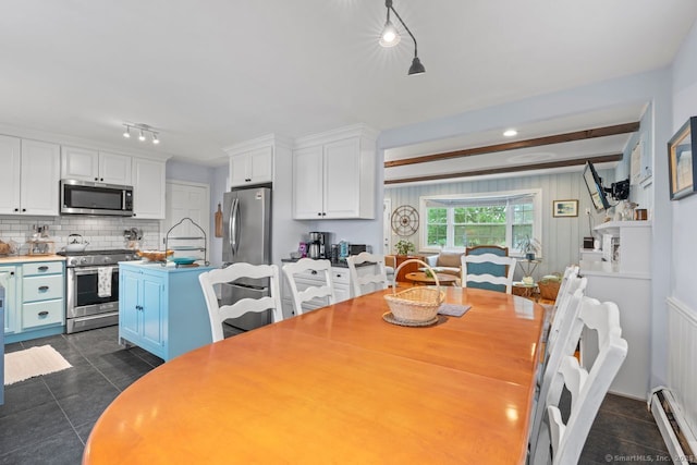 52 Seaside Ave, Guilford, CT 06437 - dining space with a baseboard radiator, track lighting, and dark tile patterned floors