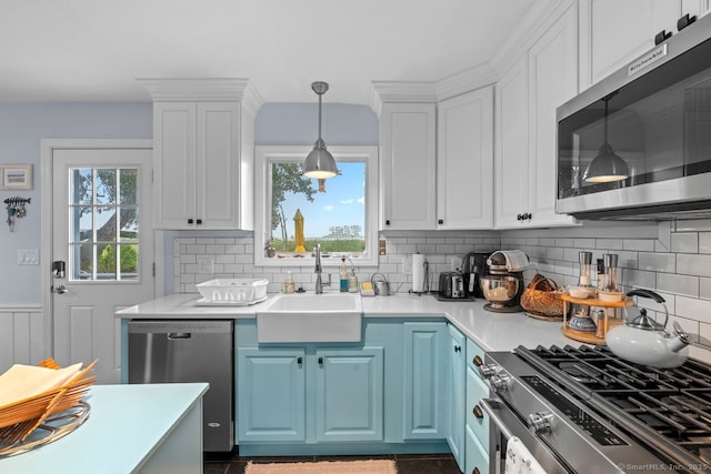 52 Seaside Ave, Guilford, CT 06437 - kitchen featuring appliances with stainless steel finishes, blue cabinets, white cabinets, light countertops, and a wainscoted wall