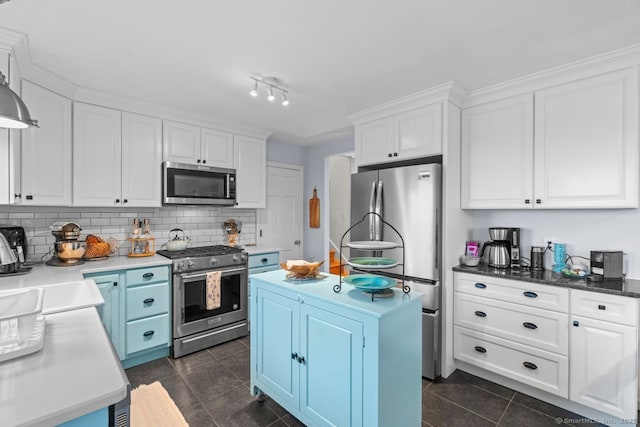 52 Seaside Ave, Guilford, CT 06437 - kitchen featuring stainless steel appliances, white cabinetry, backsplash, a center island, and dark tile patterned floors