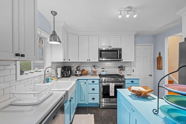 52 Seaside Ave, Guilford, CT 06437 - kitchen with appliances with stainless steel finishes, blue cabinets, light countertops, decorative backsplash, and white cabinetry