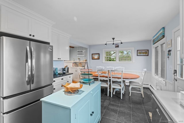 52 Seaside Ave, Guilford, CT 06437 - kitchen with freestanding refrigerator, white cabinetry, a kitchen island, a wall mounted AC, and dark tile patterned flooring