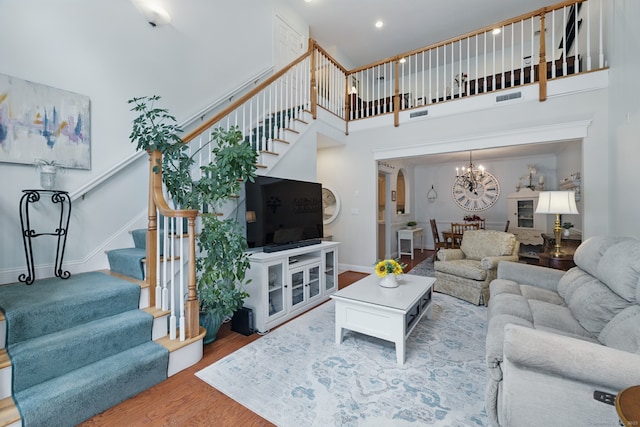 67 Southwick Ct Unit 67, Cheshire, CT 06410 - living room with stairs, a chandelier, wood finished floors, a high ceiling, and recessed lighting