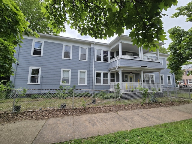 516 Dixwell Ave, New Haven, CT 06511 - back of property featuring a balcony, a fenced front yard, and a porch