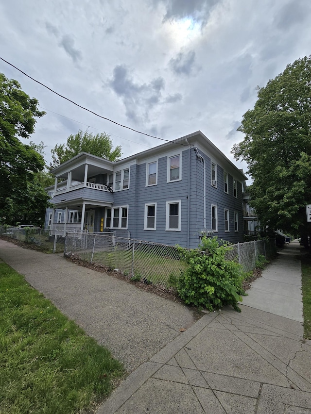 516 Dixwell Ave, New Haven, CT 06511 - view of front of house with a balcony and a fenced front yard