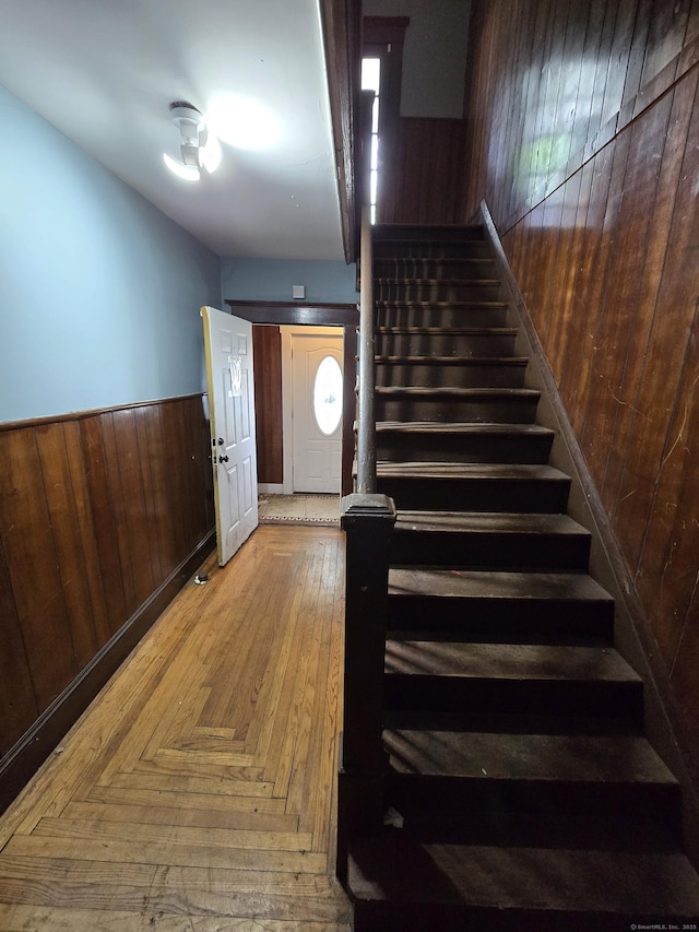 516 Dixwell Ave, New Haven, CT 06511 - stairs featuring wood walls, wainscoting, and wood finished floors