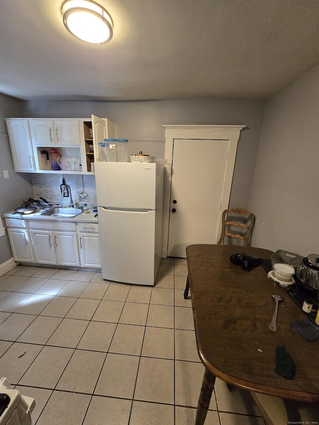 516 Dixwell Ave, New Haven, CT 06511 - kitchen featuring freestanding refrigerator, light tile patterned flooring, open shelves, white cabinets, and light countertops