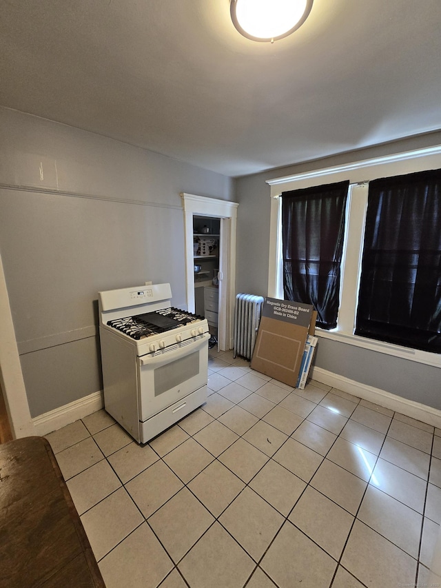 516 Dixwell Ave, New Haven, CT 06511 - kitchen featuring white range with gas stovetop, radiator heating unit, and light tile patterned floors