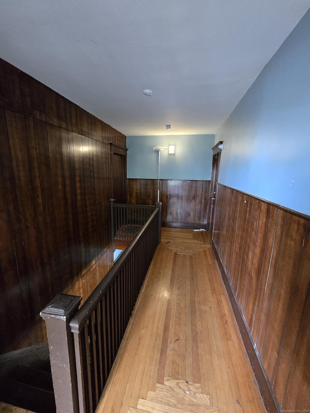 516 Dixwell Ave, New Haven, CT 06511 - hall with wainscoting, wood walls, light wood-style flooring, and an upstairs landing
