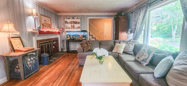 4 Tryon Rd, Norwalk, CT 06851 - living area with crown molding, stairway, wood-type flooring, plenty of natural light, and a glass covered fireplace