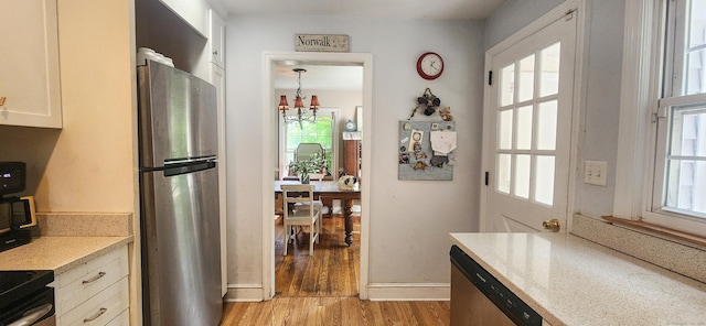4 Tryon Rd, Norwalk, CT 06851 - kitchen with appliances with stainless steel finishes, a chandelier, light wood-style floors, and healthy amount of natural light