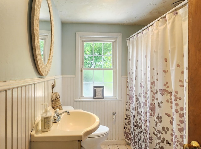 4 Tryon Rd, Norwalk, CT 06851 - full bath with wainscoting, tile patterned floors, and curtained shower