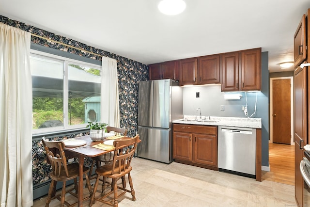 95 Lauter Ave, Windham, CT 06226 - kitchen featuring stainless steel appliances, wallpapered walls, and light stone countertops