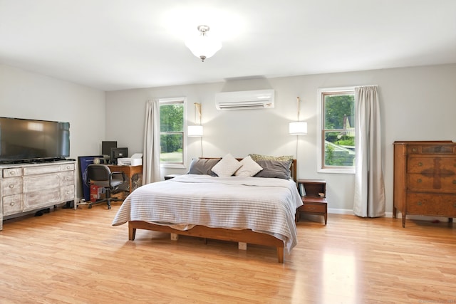 95 Lauter Ave, Windham, CT 06226 - bedroom with a wall mounted AC, multiple windows, and light wood-type flooring