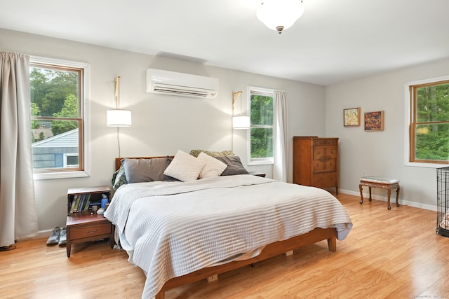 95 Lauter Ave, Windham, CT 06226 - bedroom featuring a wall unit AC, light wood-style floors, and multiple windows