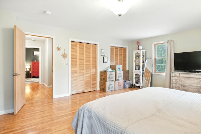 95 Lauter Ave, Windham, CT 06226 - bedroom with two closets, light wood-style flooring, and a wall mounted AC