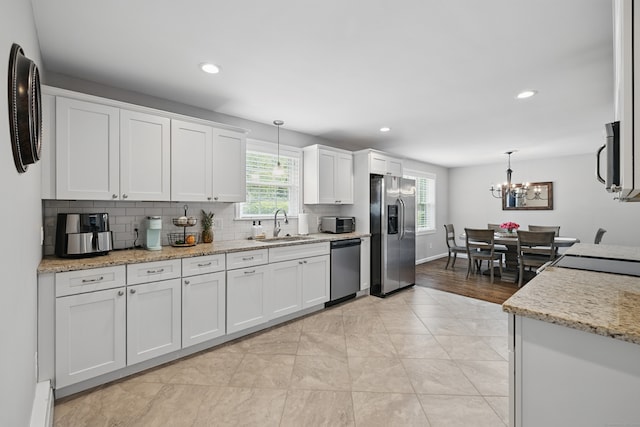 197 Webb Rd, Naugatuck, CT 06770 - kitchen featuring appliances with stainless steel finishes, a sink, healthy amount of natural light, white cabinetry, and recessed lighting