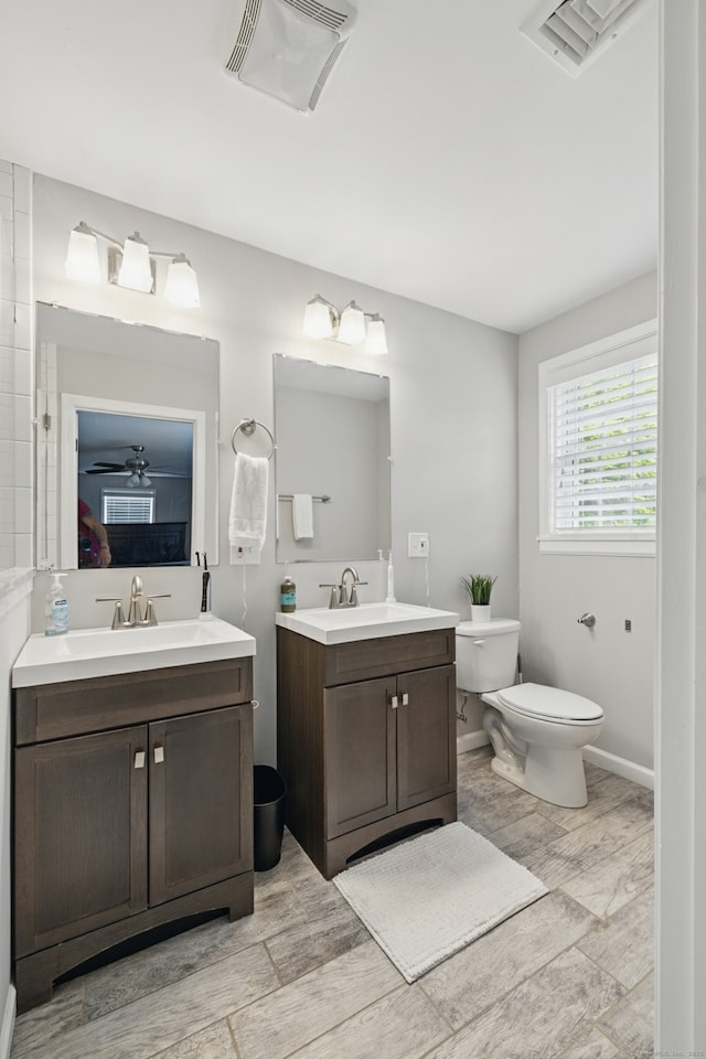 197 Webb Rd, Naugatuck, CT 06770 - full bath featuring toilet, two vanities, wood finished floors, and baseboards