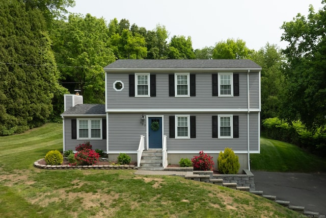 197 Webb Rd, Naugatuck, CT 06770 - colonial inspired home featuring entry steps, a front yard, and a chimney