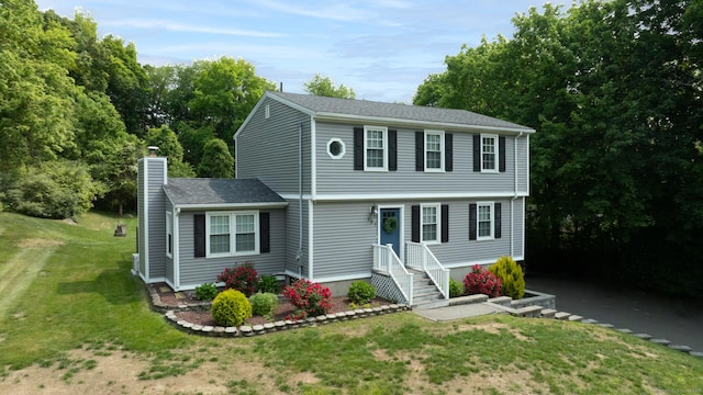 197 Webb Rd, Naugatuck, CT 06770 - colonial house featuring a chimney and a front yard