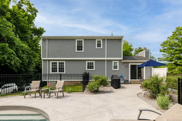 197 Webb Rd, Naugatuck, CT 06770 - back of property with a patio area, entry steps, and a chimney