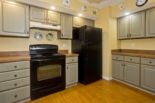 11 Oxford Dr Unit 11, Suffield, CT 06078 - kitchen with black appliances, under cabinet range hood, and light wood-type flooring