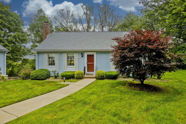 11 Oxford Dr Unit 11, Suffield, CT 06078 - view of front of house featuring a chimney, a front yard, and roof with shingles