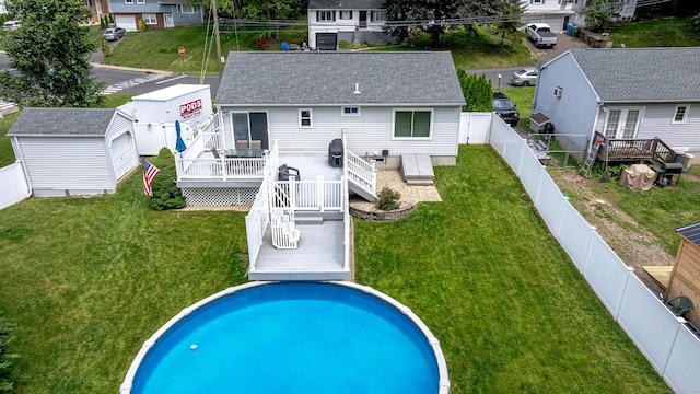 30 Lewis Rd, Bristol, CT 06010 - back of property with a deck, a fenced backyard, and roof with shingles