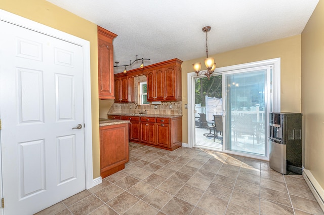 30 Lewis Rd, Bristol, CT 06010 - kitchen with light countertops, a chandelier, tasteful backsplash, brown cabinets, and hanging light fixtures