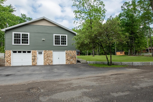 11 Breaults Landing Rd, Thompson, CT 06277 - view of side of home featuring stone siding, driveway, and a yard
