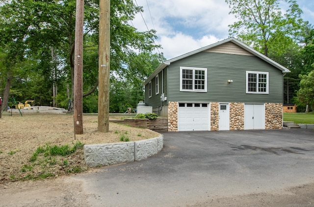 11 Breaults Landing Rd, Thompson, CT 06277 - view of side of home featuring stone siding and driveway