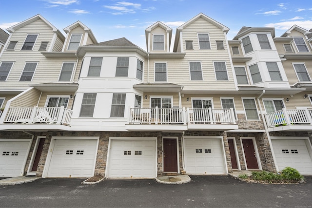 85 Camp Ave Apt 11J, Stamford, CT 06907 - townhome / multi-family property with stone siding, a garage, and driveway