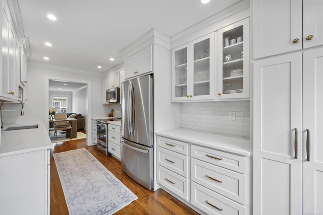 85 Camp Ave Apt 11J, Stamford, CT 06907 - kitchen featuring stainless steel appliances, crown molding, recessed lighting, white cabinets, and glass insert cabinets