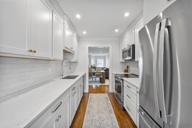 85 Camp Ave Apt 11J, Stamford, CT 06907 - kitchen featuring stainless steel appliances, dark wood-style flooring, white cabinetry, light stone counters, and backsplash