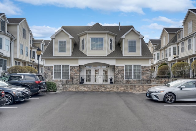 85 Camp Ave Apt 11J, Stamford, CT 06907 - view of front of house featuring stone siding, roof with shingles, and uncovered parking