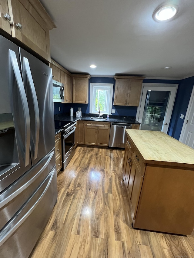 51 Brook St Apt 3C, Naugatuck, CT 06770 - kitchen featuring appliances with stainless steel finishes, butcher block counters, a sink, light wood-type flooring, and a center island