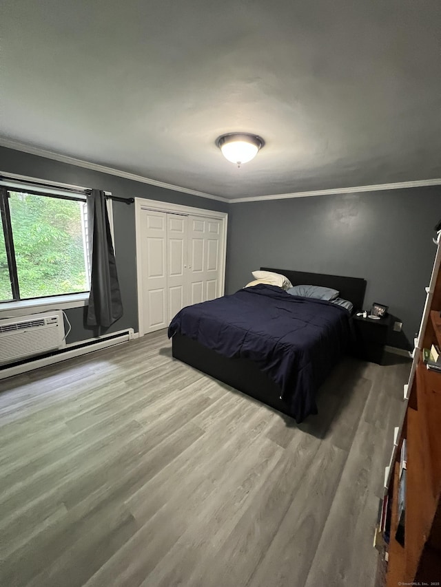 51 Brook St Apt 3C, Naugatuck, CT 06770 - bedroom with crown molding, wood finished floors, a closet, and a baseboard radiator