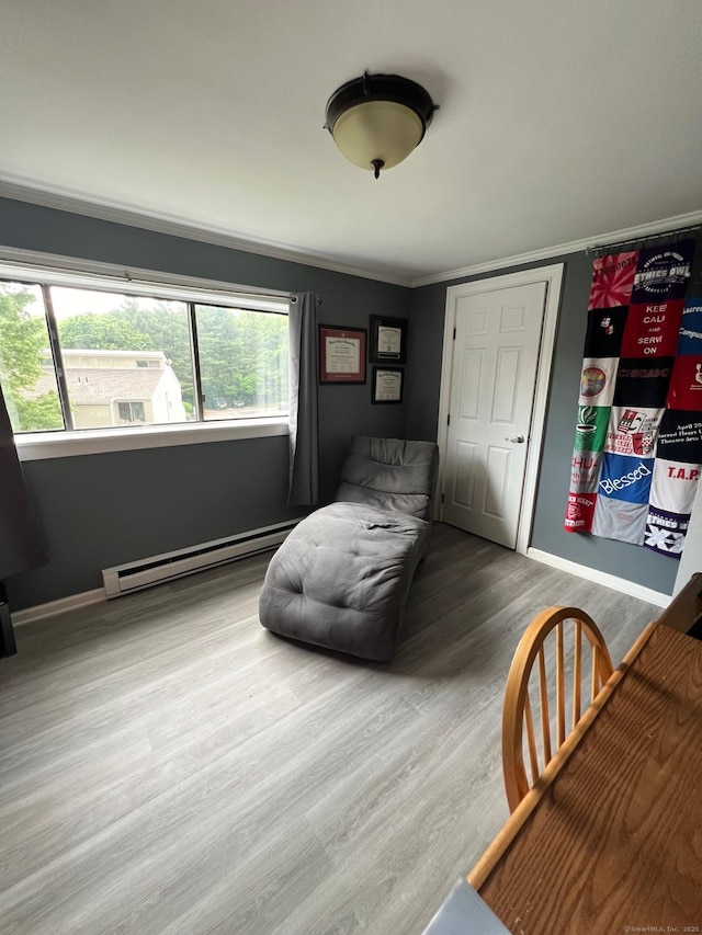 51 Brook St Apt 3C, Naugatuck, CT 06770 - living area featuring a baseboard radiator, wood finished floors, crown molding, and baseboards