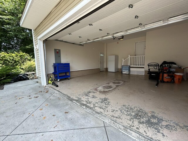 756 Hart St, Bridgeport, CT 06606 - garage with freestanding refrigerator, a garage door opener, and electric panel