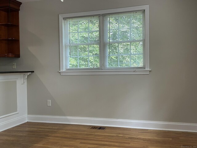 756 Hart St, Bridgeport, CT 06606 - unfurnished dining area with dark wood-type flooring and healthy amount of natural light